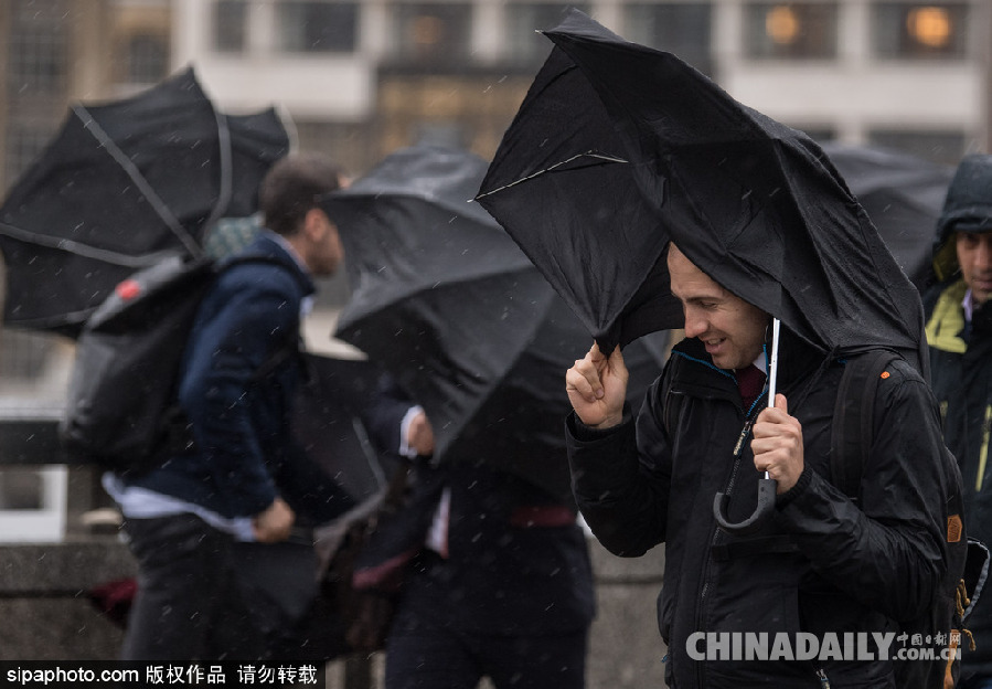 英國倫敦雨天狂風大作 民眾出行雨傘被吹翻